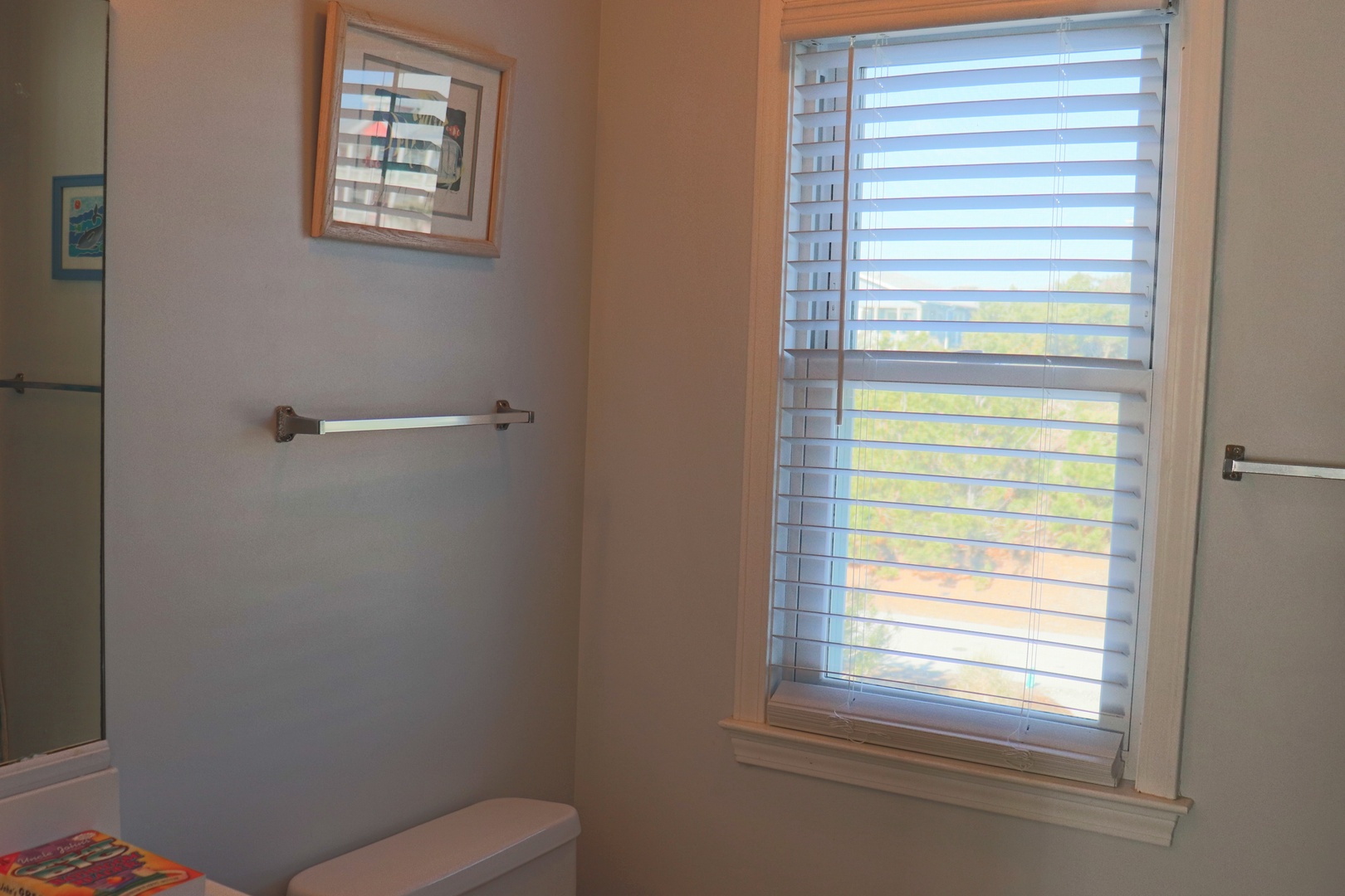 Relax in your private bathroom with natural light streaming through elegant blinds, creating a peaceful morning routine space.