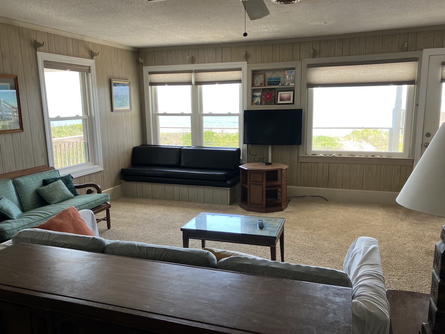 Relax in your spacious living room with ocean views, cozy seating, and entertainment center—perfect for unwinding after beach days.