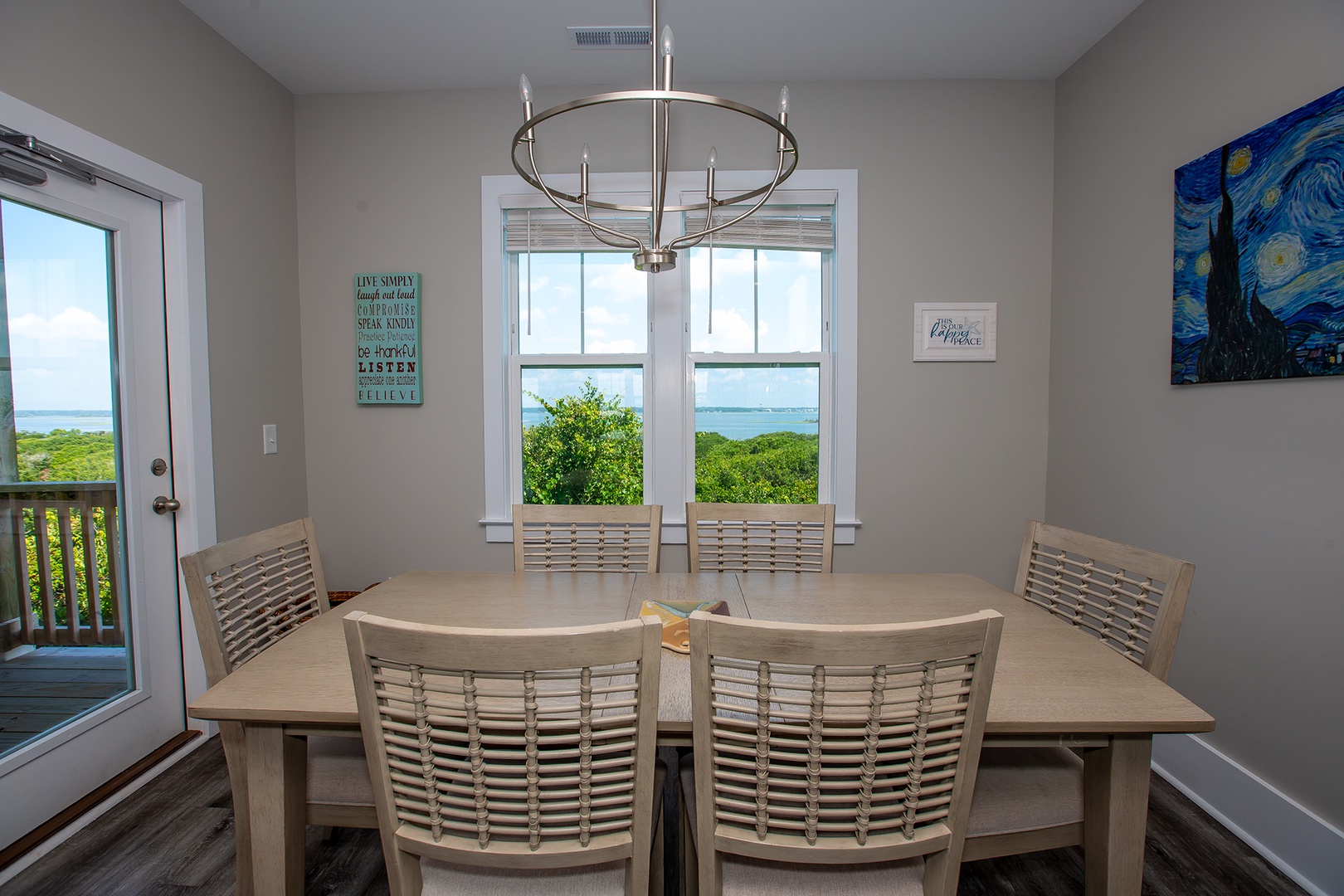 Gather around this inviting dining table where morning coffee and evening meals become special with stunning water views through your window.