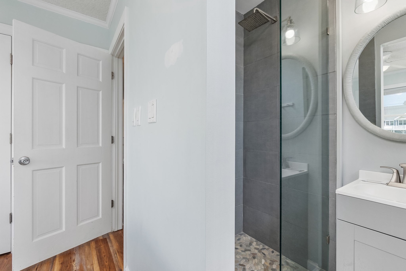 Step into your sleek modern bathroom with a spacious glass shower and contemporary finishes for a refreshing start to each day.