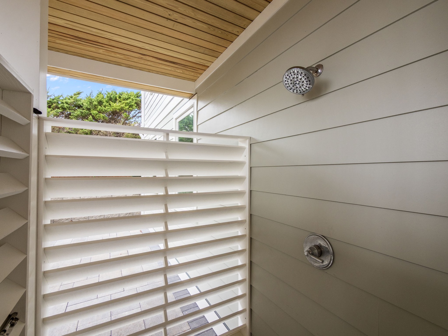 Rinse off under open sky in your private outdoor shower, where warm wood meets fresh air for a refreshing tropical experience.