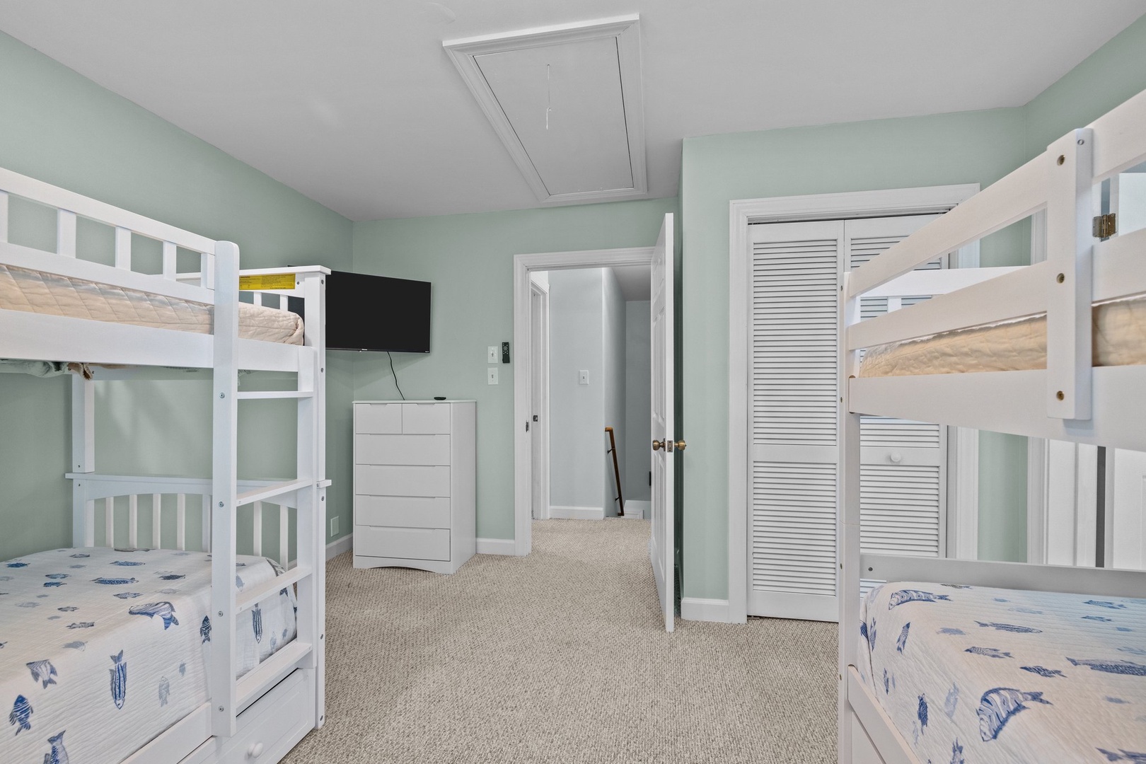 Your kids will love this cheerful bunk room with twin beds, wall-mounted TV, and plenty of storage space for all their vacation treasures.