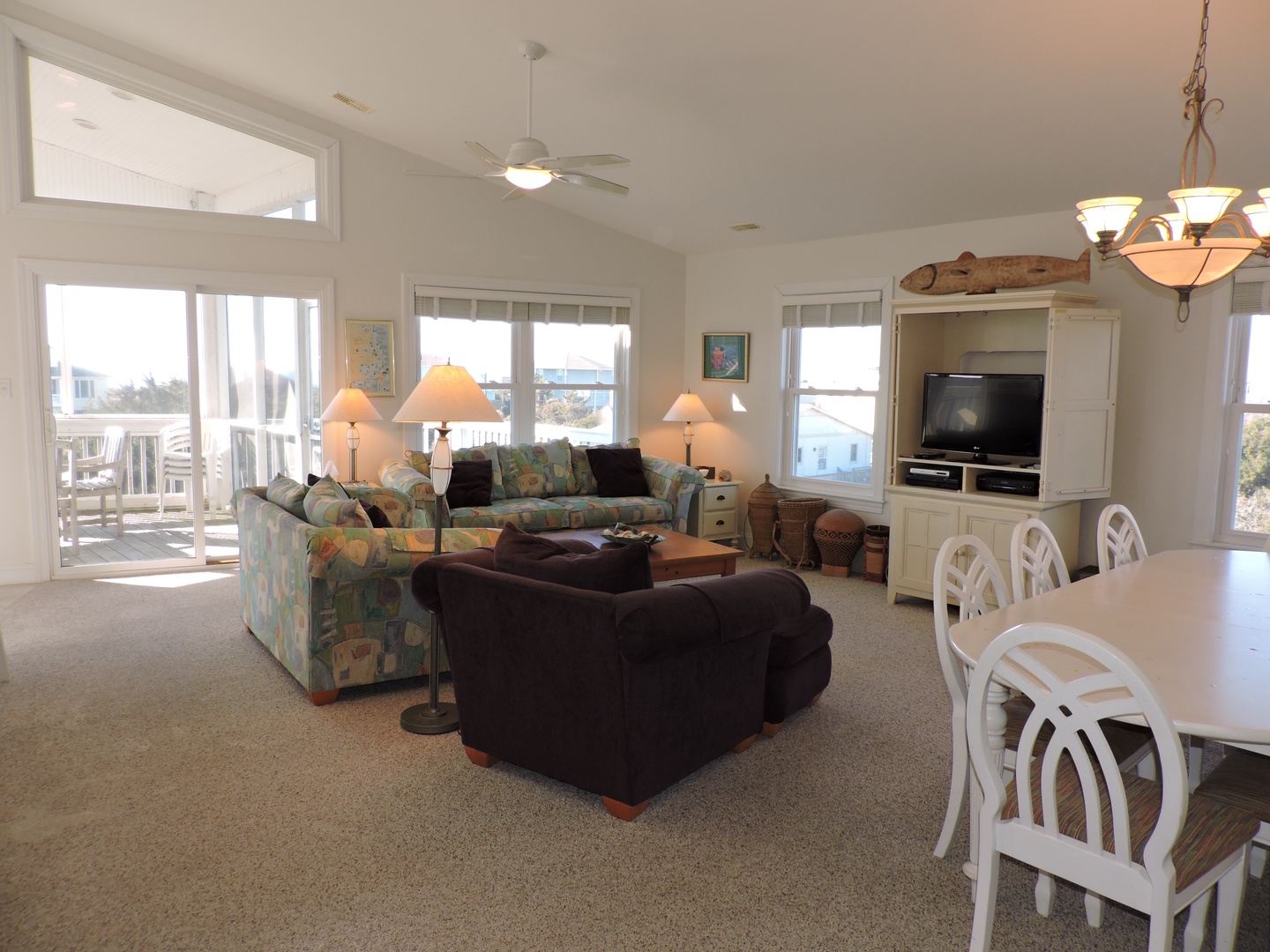 Relax in your spacious living room with comfy seating, ocean views, and coastal charm perfect for gathering with loved ones.