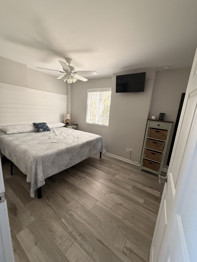 Your bright and peaceful bedroom awaits with a plush bed, natural light from the window, and modern finishes throughout—the perfect retreat to unwind after exploring.