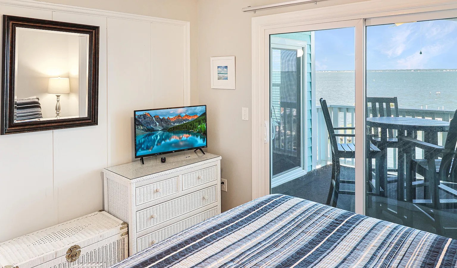 Wake up to ocean views from your comfortable bedroom, complete with modern TV and private balcony access for morning coffee or sunset relaxation.