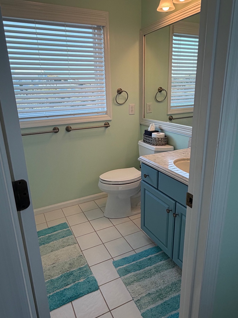 Your private bathroom features a relaxing tub-shower combo with coastal colors and soft towels for your comfort.