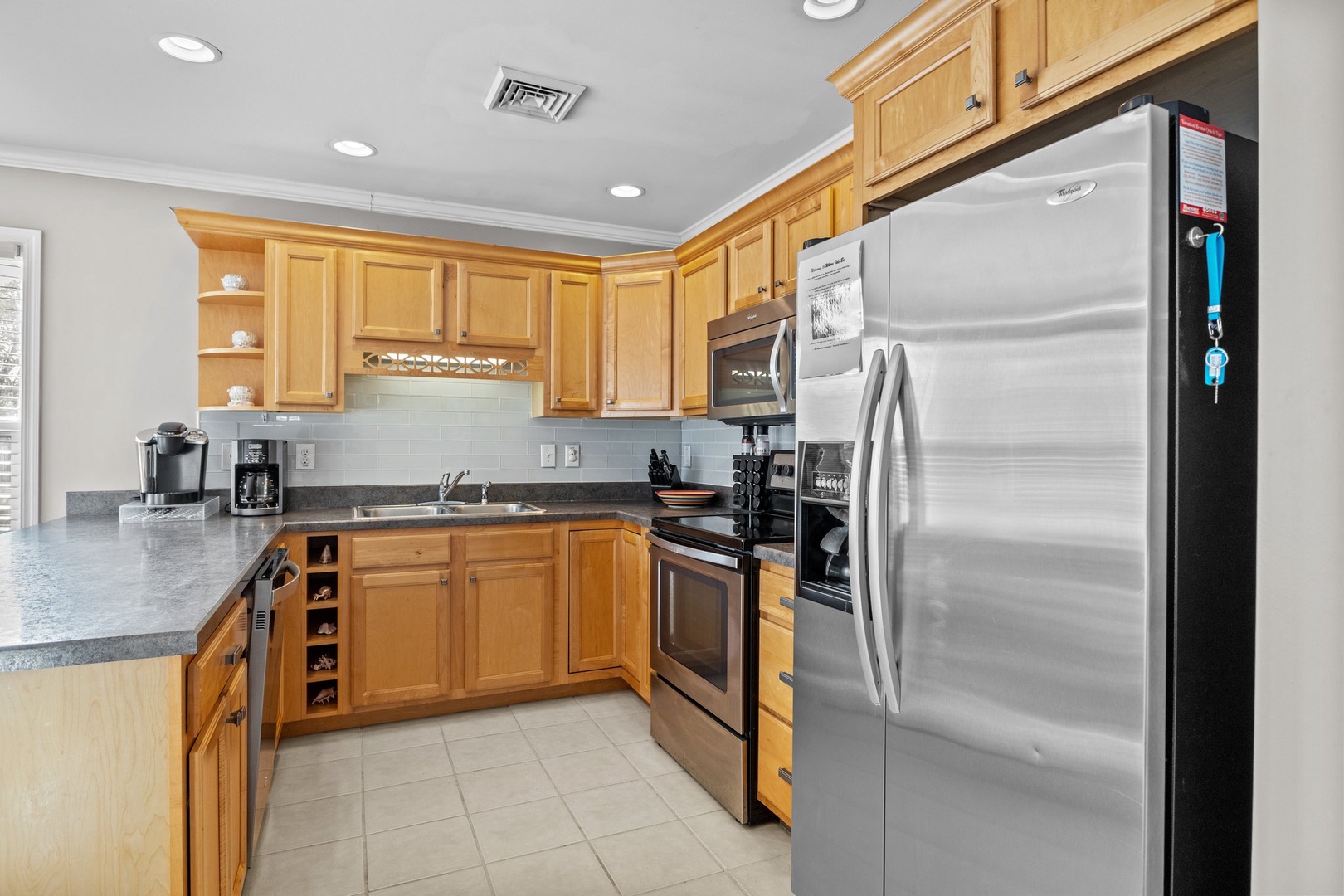 Your fully-equipped kitchen awaits with granite counters, stainless appliances, and warm wood cabinets—perfect for creating memorable meals together.