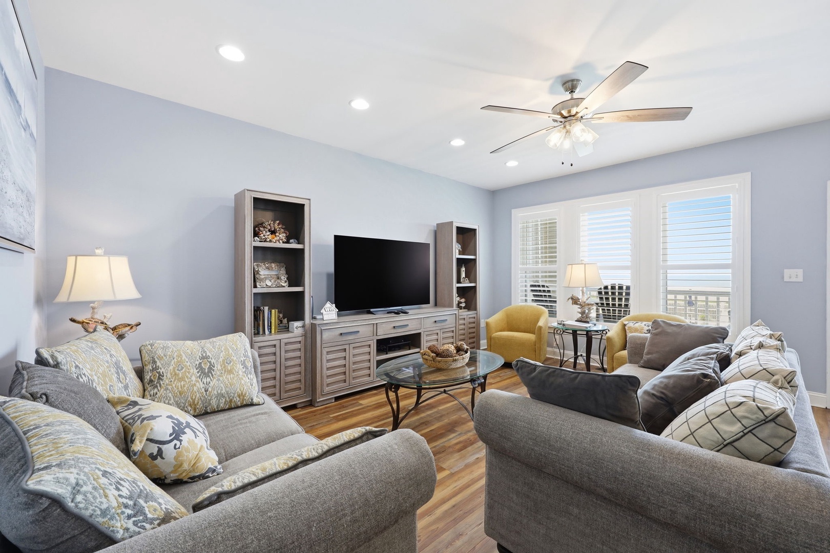 Sink into plush seating and enjoy your favorite shows in this bright, airy living room with serene views and all the comforts of home.