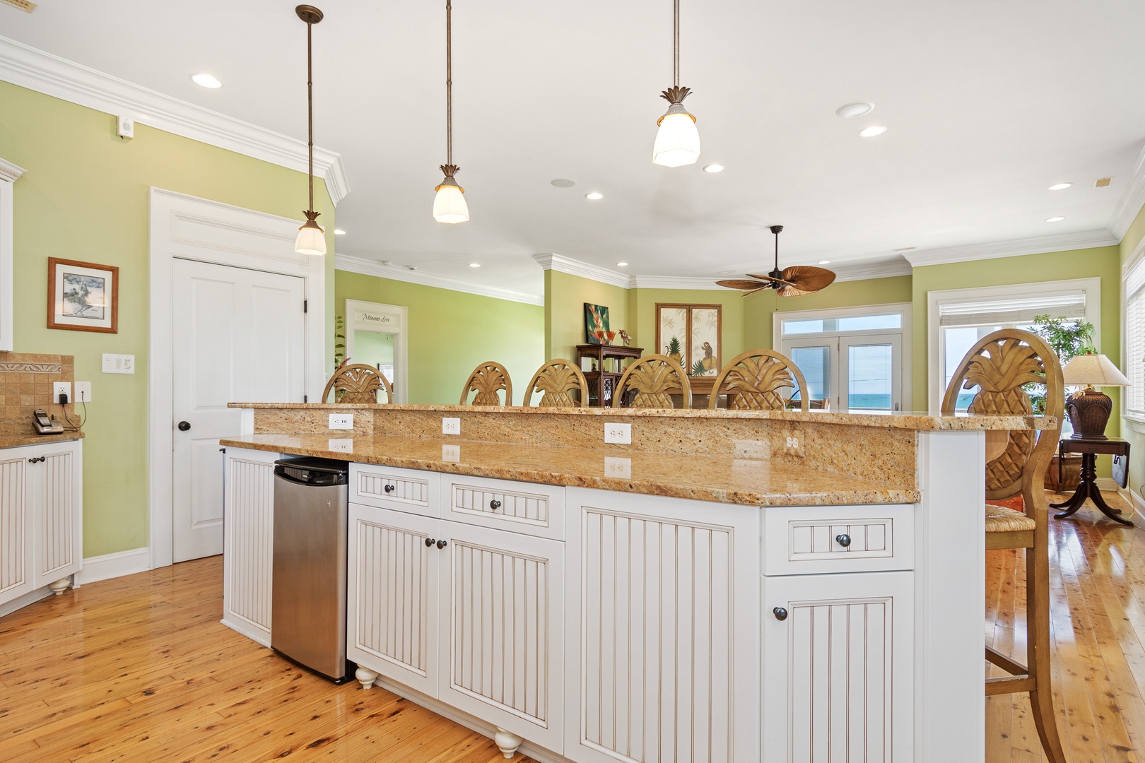Your spacious kitchen features granite countertops and tropical pineapple pendant lights, perfect for preparing meals while chatting with family.