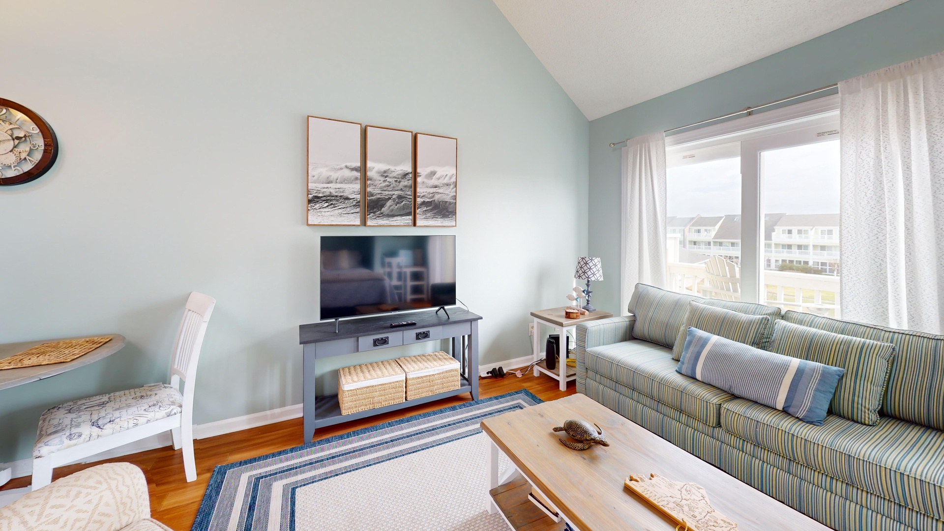 Unwind in your peaceful living space with coastal blues, comfy seating, and mountain artwork creating the perfect retreat atmosphere.