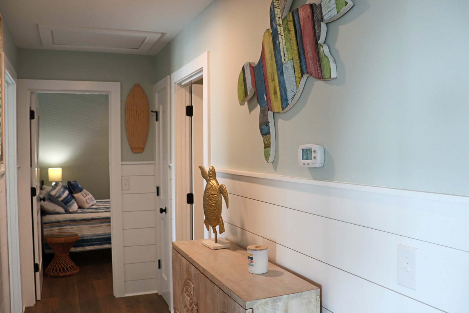 Step into your coastal retreat where weathered wood art and nautical touches create a welcoming atmosphere throughout your beachside escape.