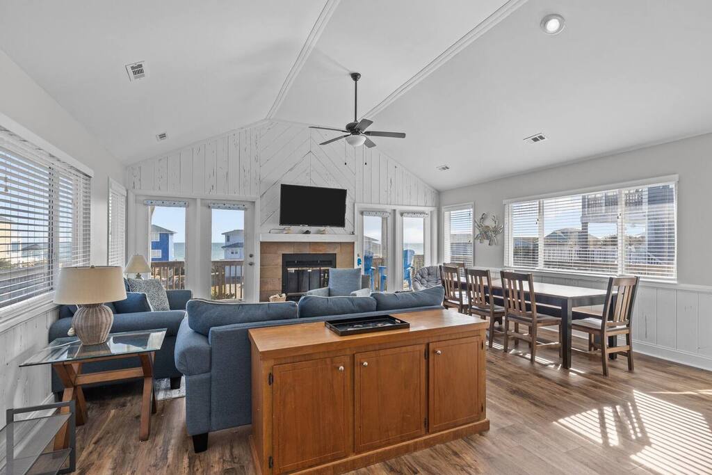 Relax in your bright, airy living space with comfortable seating, modern fireplace, and stunning views through expansive windows.