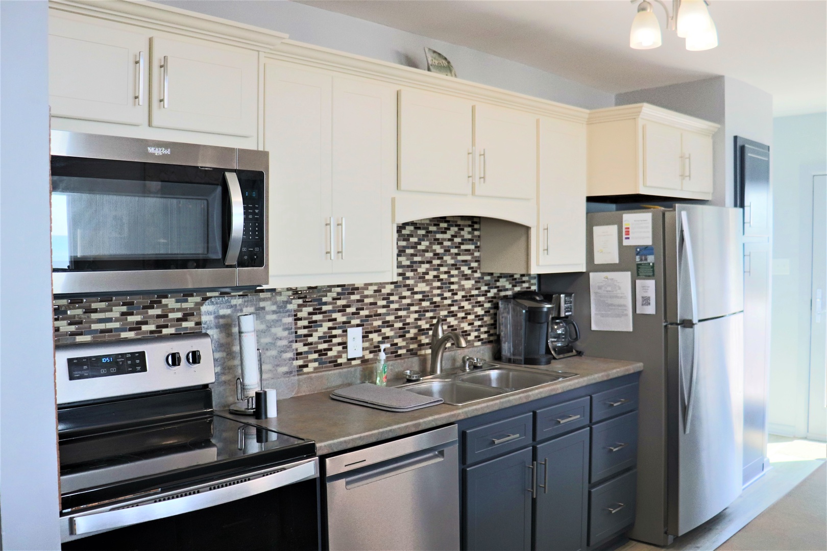 Your fully equipped kitchen features stainless steel appliances, mosaic tile backsplash, and everything you need to prepare memorable meals during your stay.