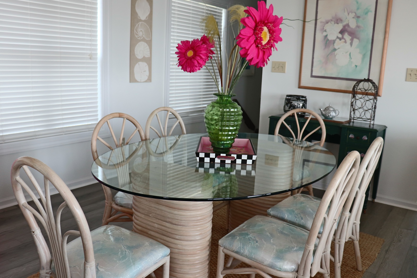 Gather around your elegant glass dining table for memorable meals together, surrounded by natural light and cheerful touches.