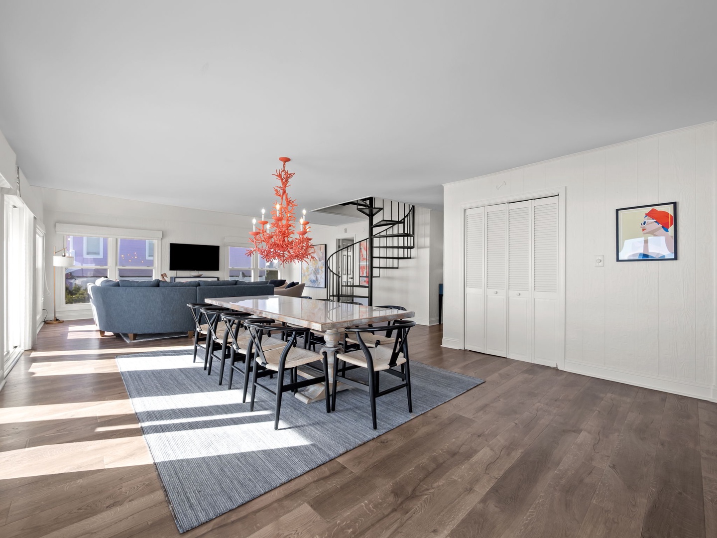 Step into your bright, open living space with stunning city views, elegant dining area, and modern spiral staircase for stylish multi-level living.