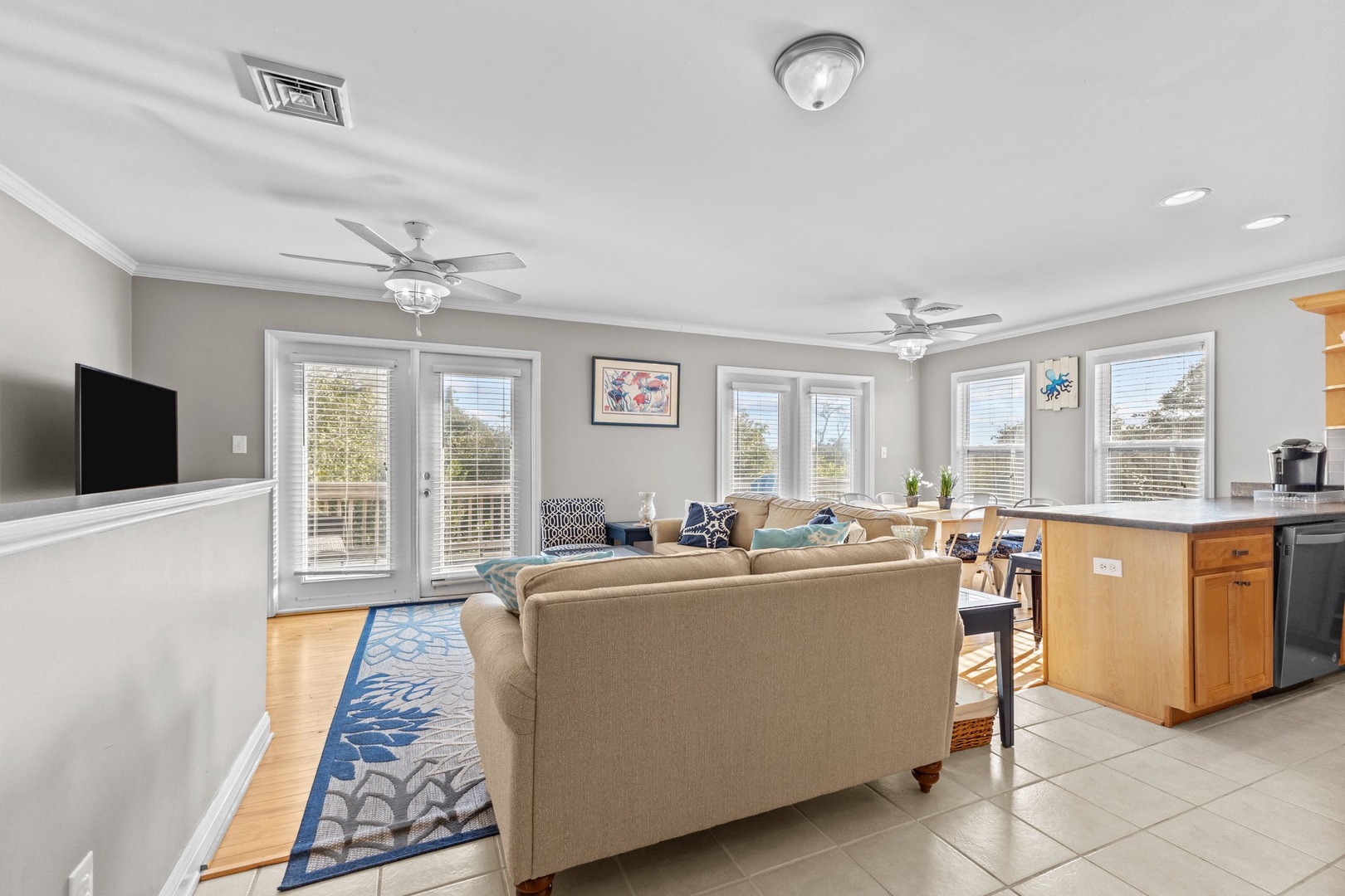 Unwind in your spacious open-concept living area with plush seating, modern kitchen, and bright windows creating the perfect backdrop for memorable vacation moments.