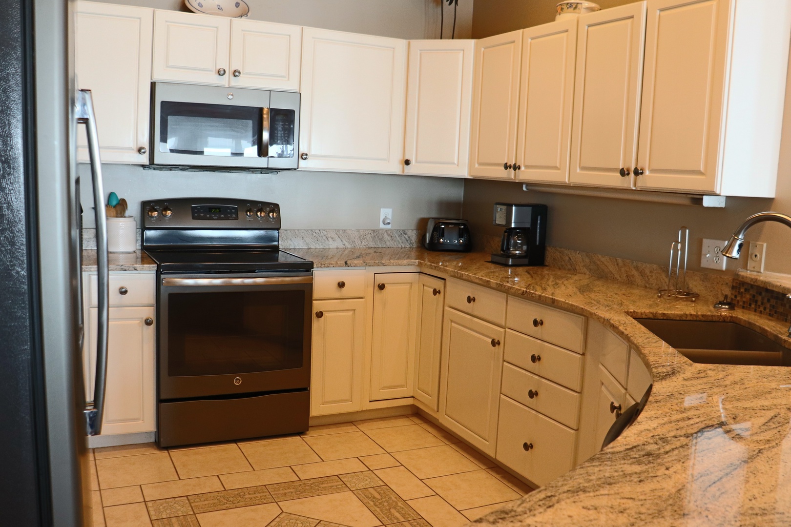 Your fully equipped kitchen features granite countertops, stainless steel appliances, and everything you need to create memorable meals during your stay.