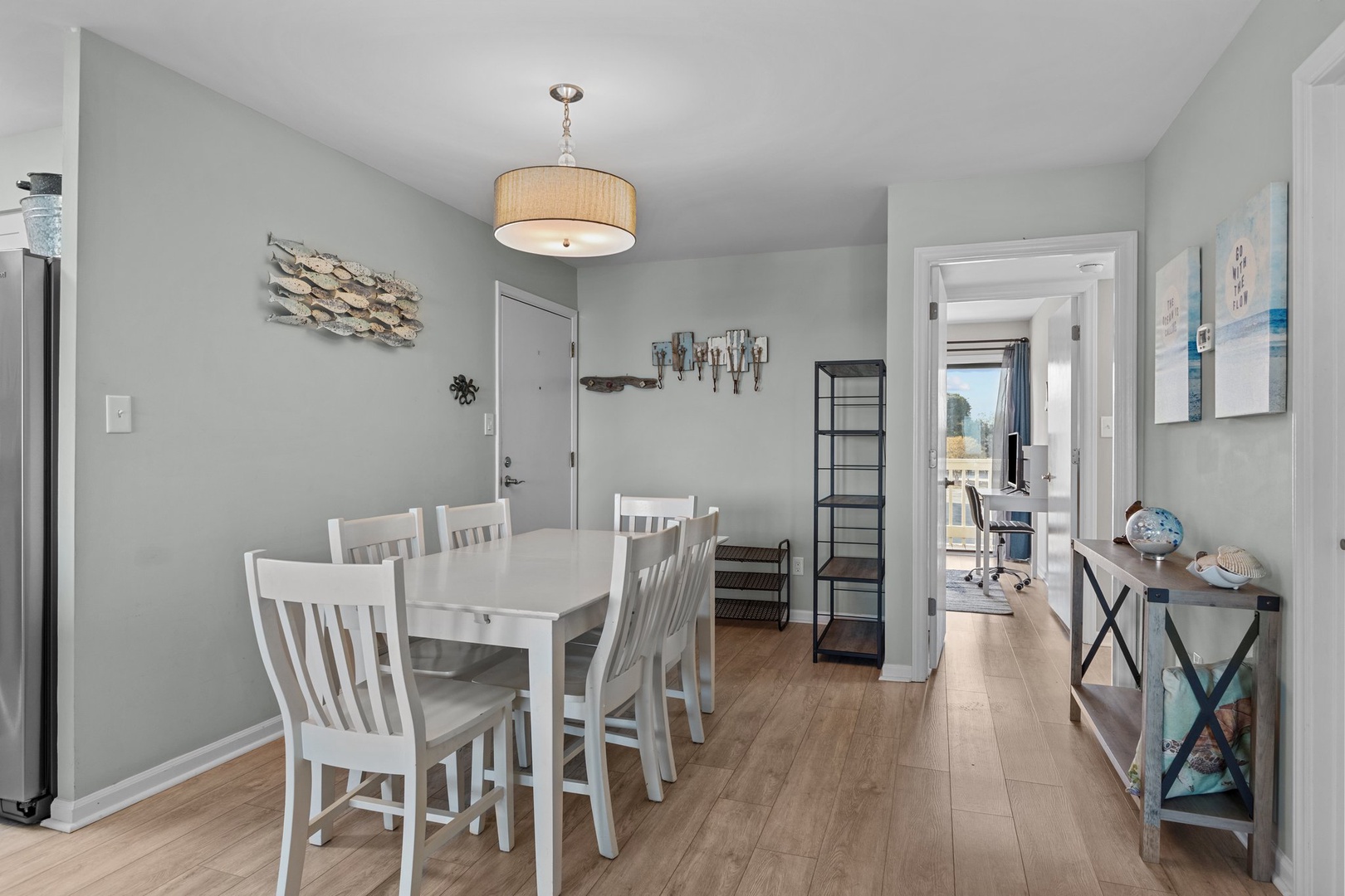 Gather around your coastal dining table under warm ambient lighting, where fresh sea-inspired decor creates the perfect backdrop for memorable meals together.