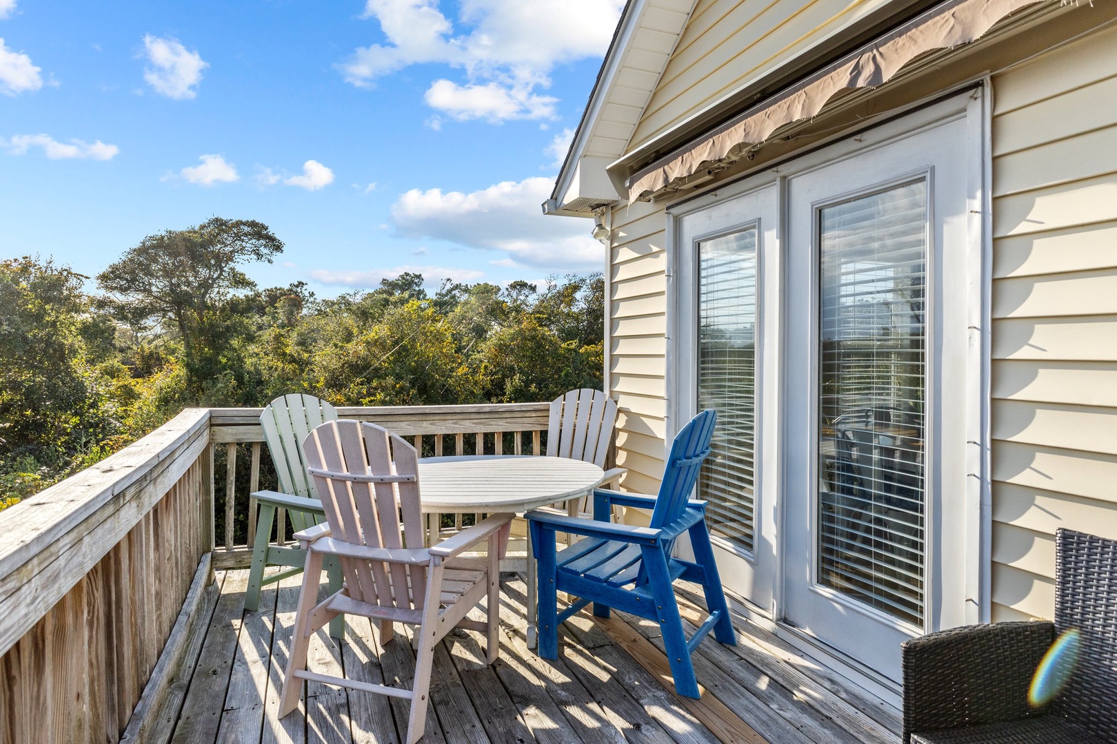 Step out onto your private deck and breathe in the peaceful tree-lined views while relaxing in comfortable Adirondack chairs.