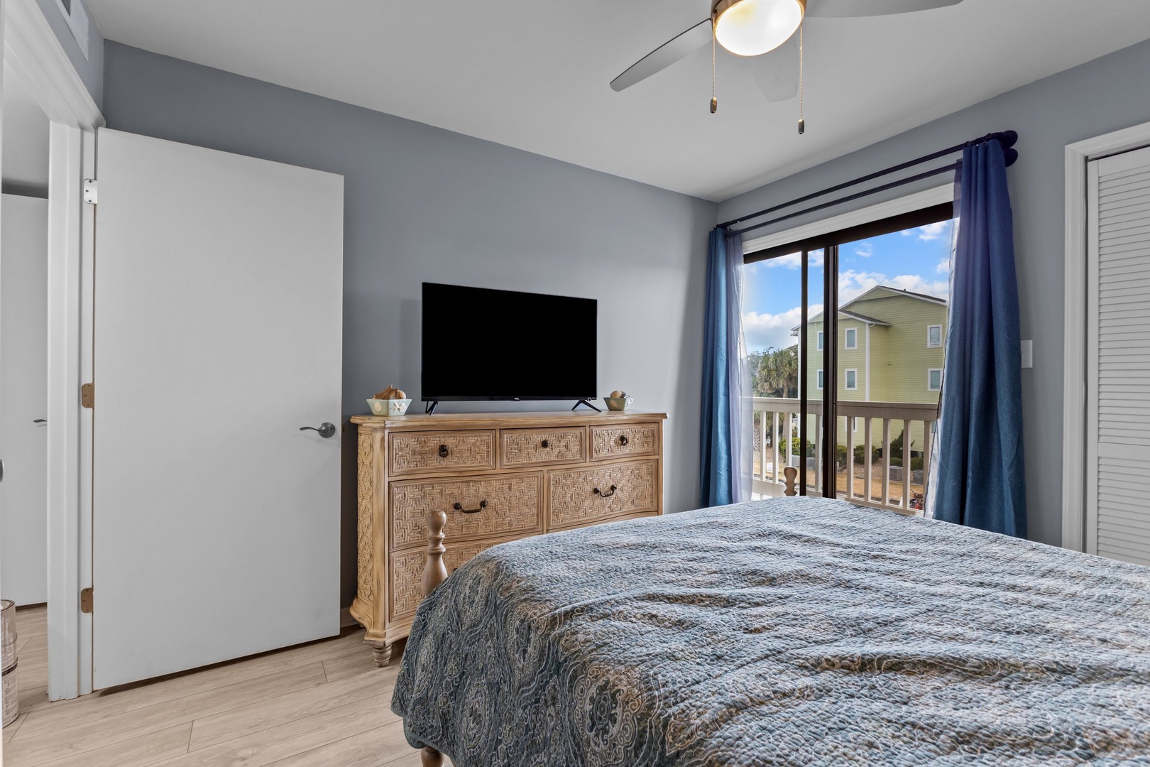 Relax in your peaceful bedroom with natural light streaming through sliding doors and your own flat-screen TV for cozy evenings in.