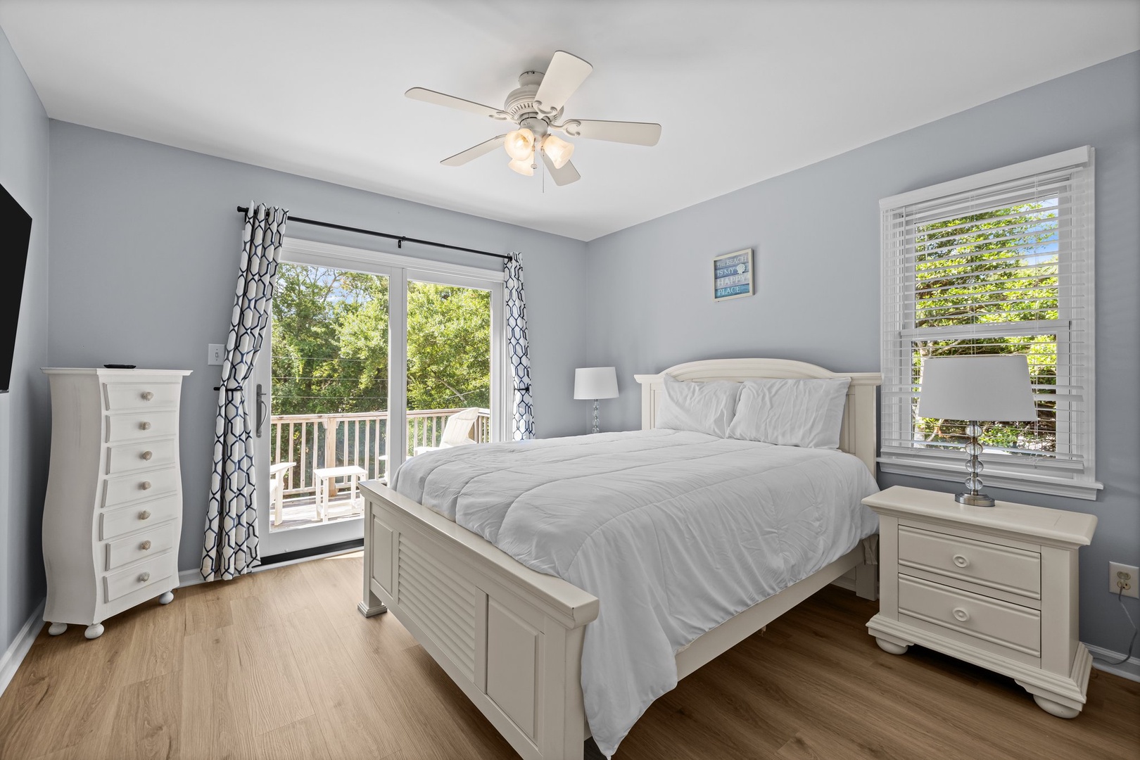 Drift off to peaceful slumber in your serene bedroom, where soft gray walls and crisp white linens create the perfect sanctuary for rest.