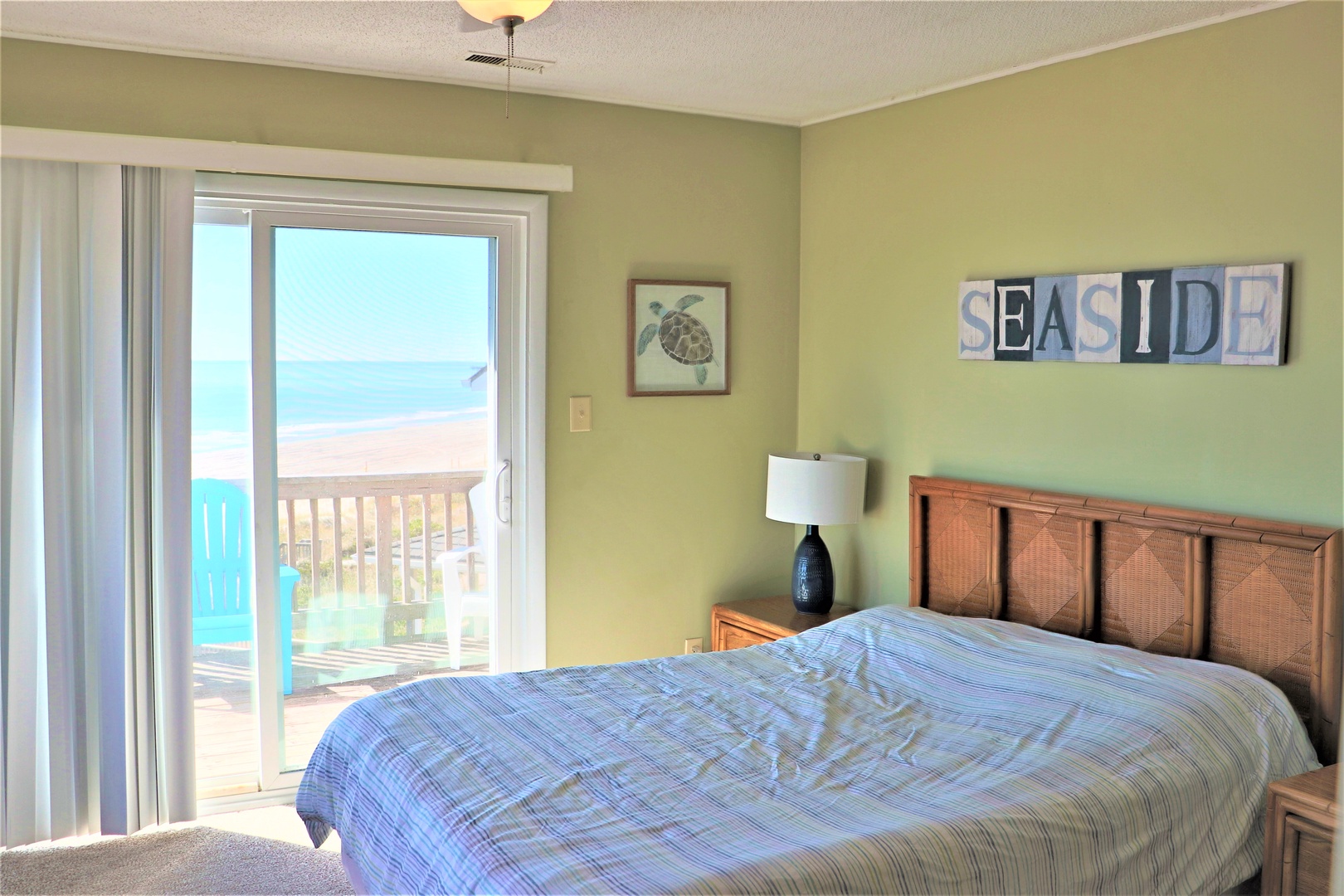 Wake up to stunning ocean views from your cozy bedroom with coastal charm and direct balcony access to the sea breeze.