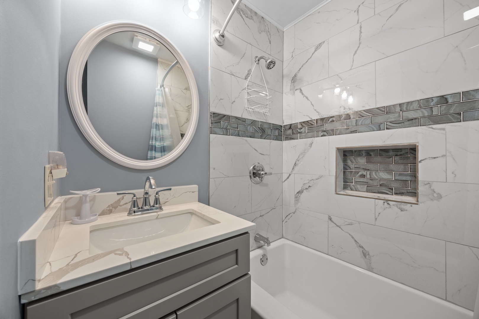 Indulge in your private spa-like bathroom with elegant marble tiles, modern fixtures, and a relaxing tub-shower combo perfect for unwinding.