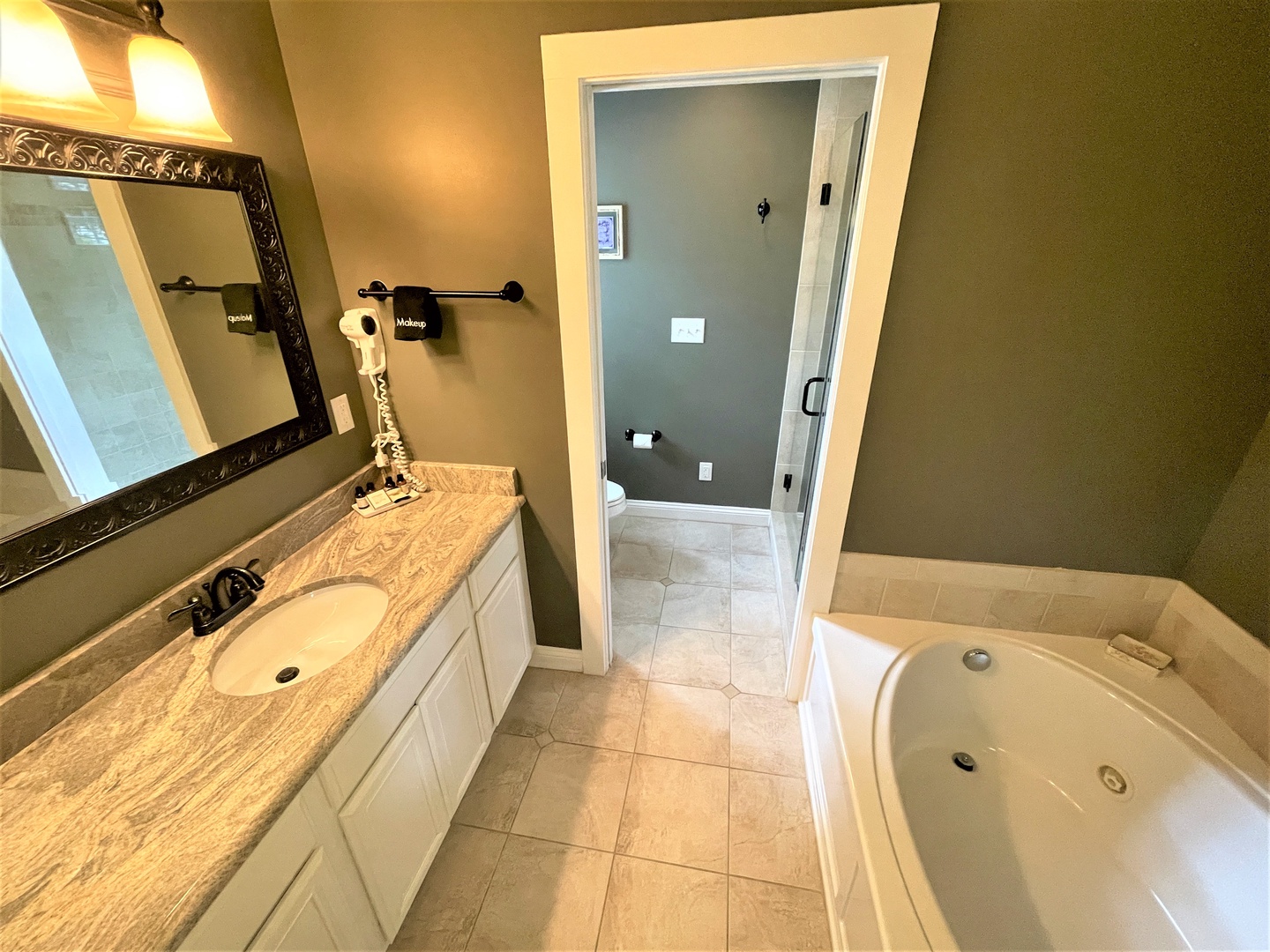 Sink into luxury with your own spa-like bathroom featuring a jetted tub and elegant finishes for ultimate relaxation.