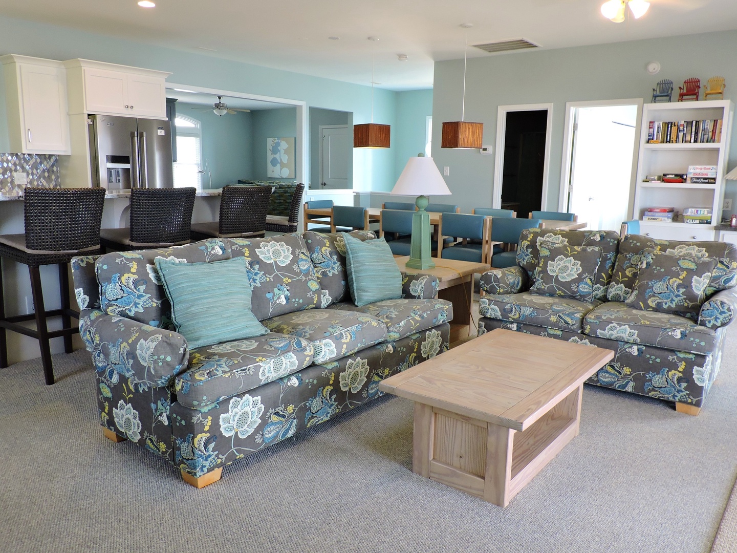 Relax in your coastal living space with floral sofas and ocean-inspired decor, where you'll feel completely at home.