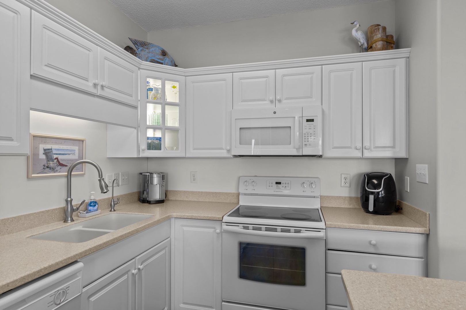 Your fully equipped kitchen invites culinary adventures with modern appliances and ample cabinet storage for all your vacation cooking needs.