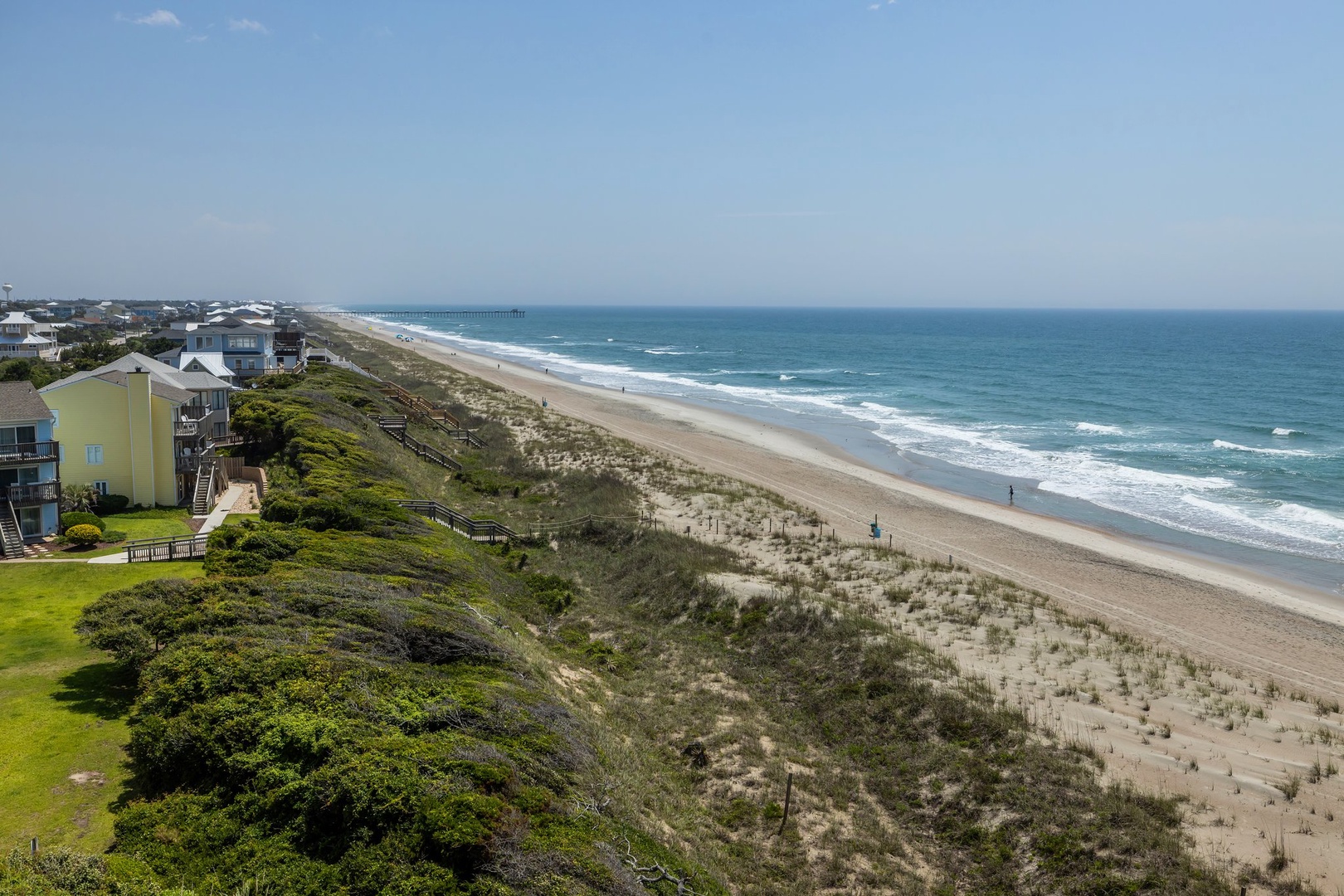 Stunning coastline with pristine beach and ocean waves stretching endlessly along the shore.