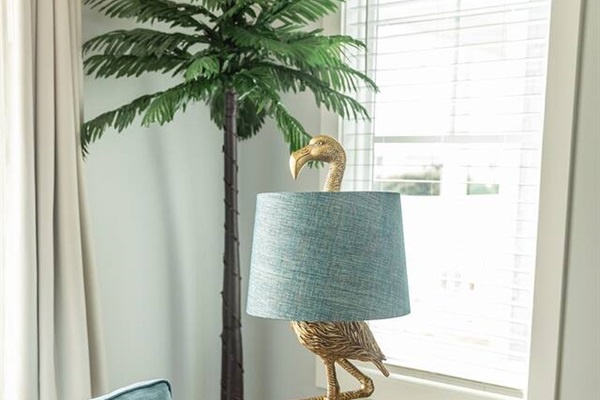 Your bright living space features a charming flamingo lamp that adds whimsical character to your tropical getaway.