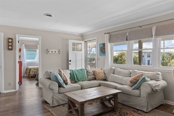 Unwind in your bright living space with plush sectional seating and peaceful views through oversized windows.