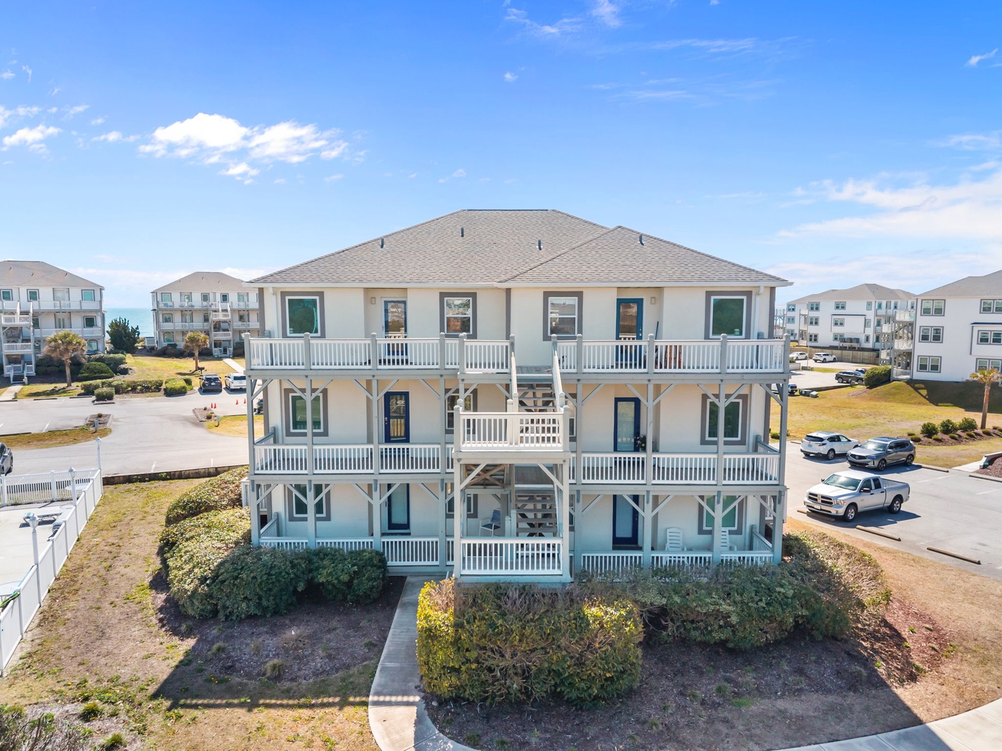 Spacious multi-level beach house with wraparound decks and coastal charm, surrounded by vacation community amenities.