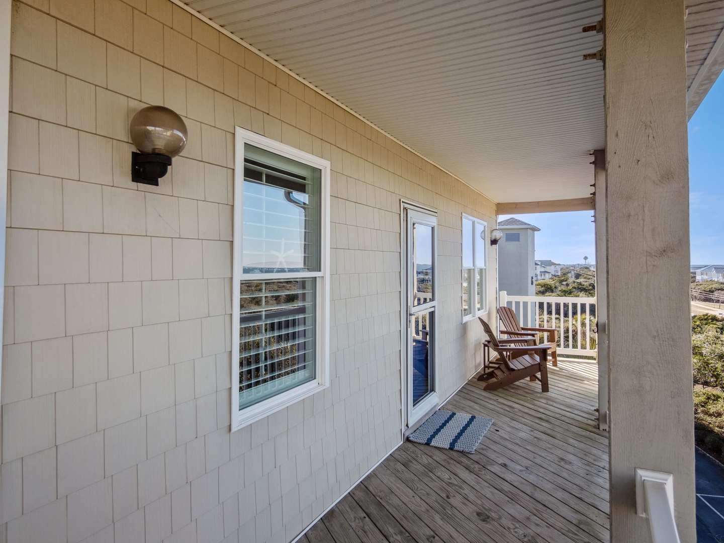 Relax on your private covered deck with cozy seating, perfect for morning coffee or unwinding after beach adventures.