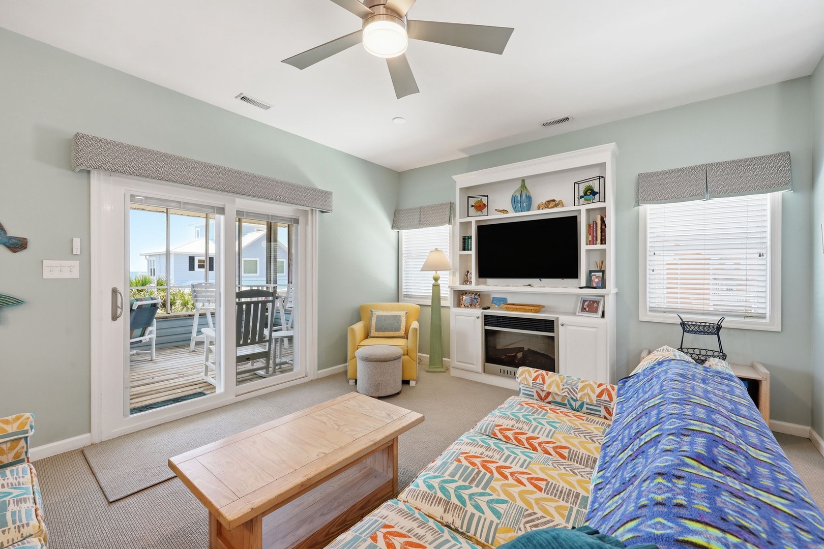 Sink into coastal comfort with soft sea-glass walls, bright pops of color, and breezy deck access. Your beachside retreat awaits with room to relax and ocean views just steps away.