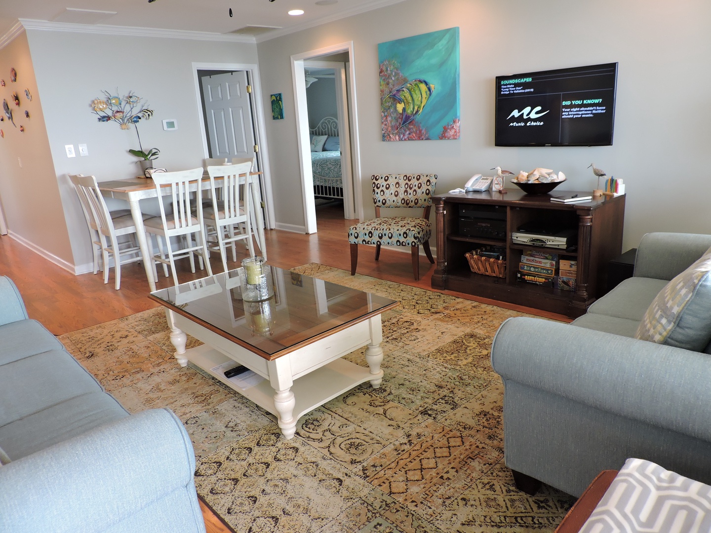 Relax in your spacious living area with comfortable seating, entertainment center, and open flow to your dining space and bedroom.