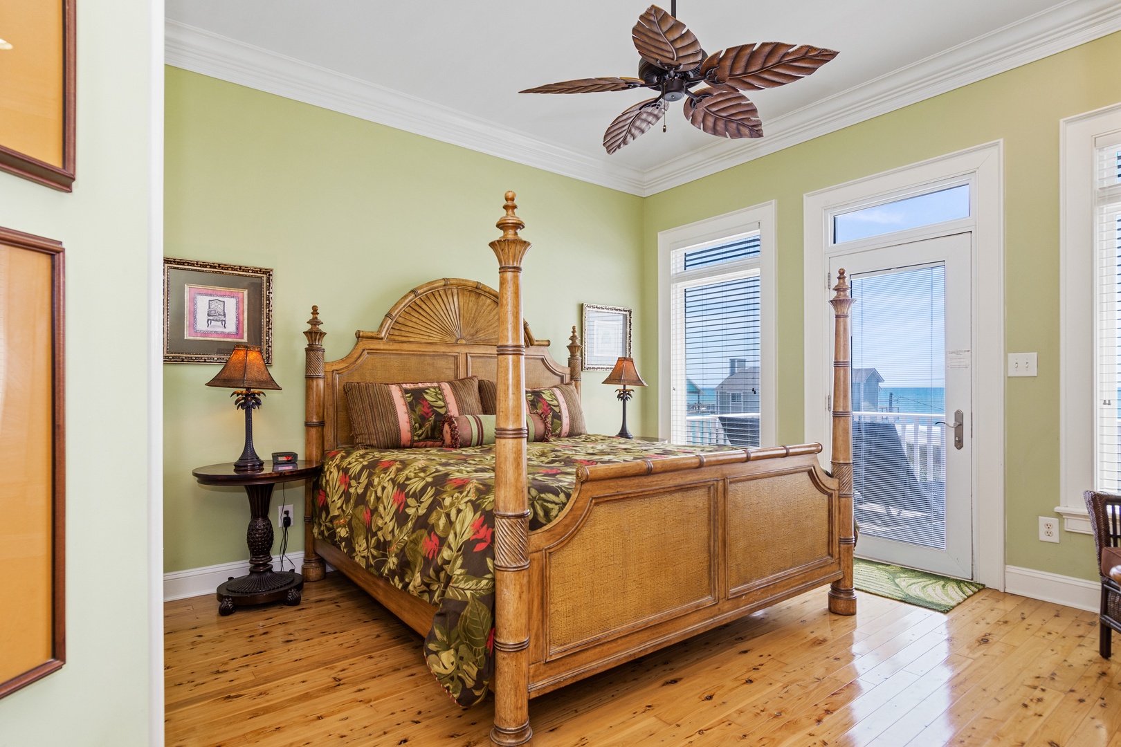 Your tropical-style bedroom features a stunning four-poster bed and private balcony access where ocean breezes flow through French doors.