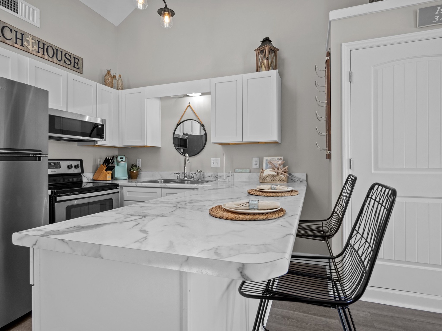 Your bright kitchen features gleaming marble countertops and modern appliances, perfect for preparing meals in style and comfort.