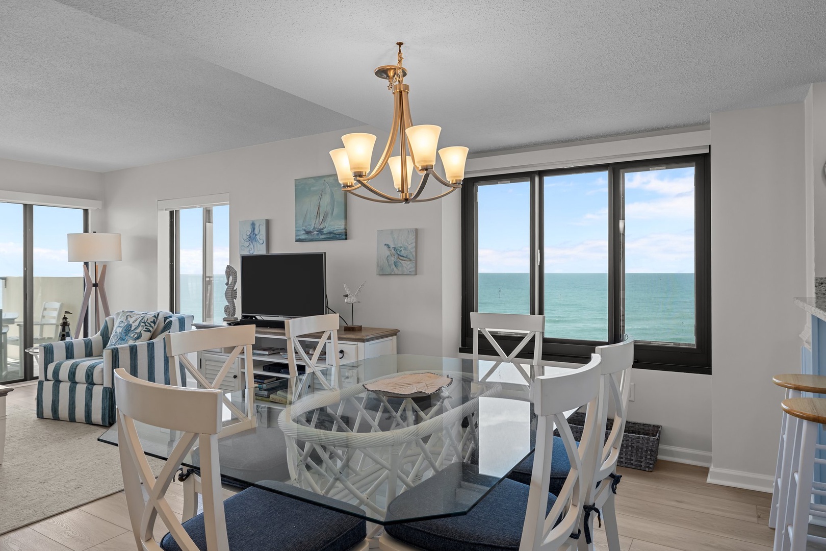 Your coastal dining space features nautical touches and stunning ocean views through floor-to-ceiling windows for memorable meals.