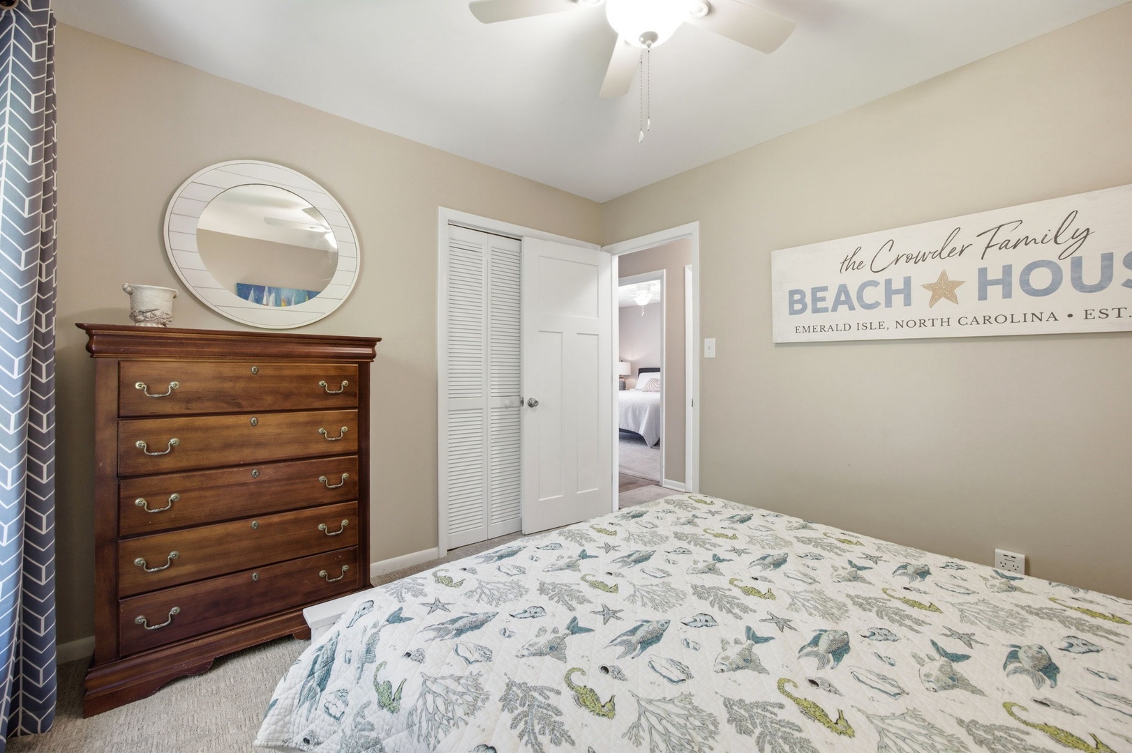 Your cozy bedroom features charming coastal decor and comfortable bedding, perfect for restful nights after beach adventures.