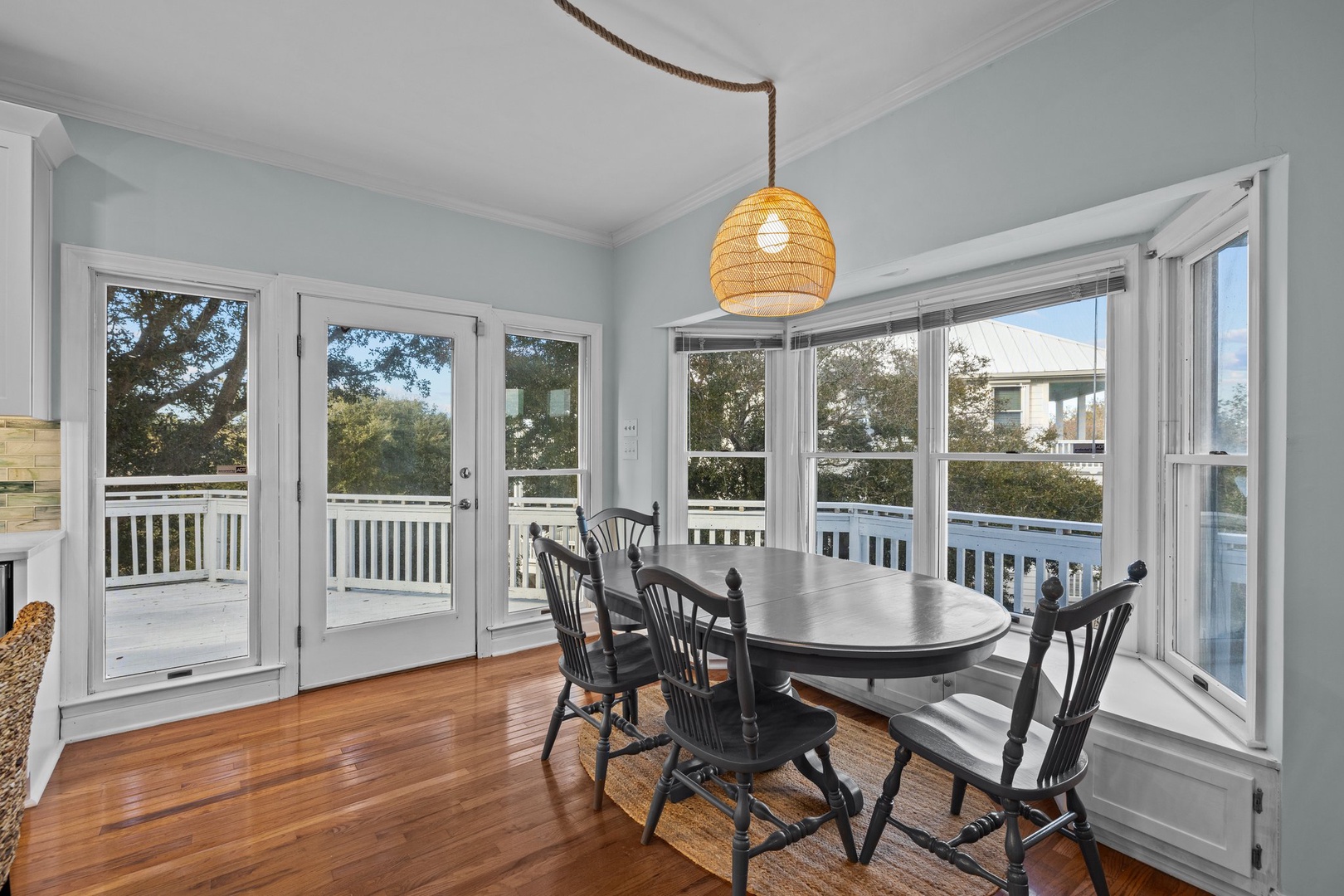 Your bright dining space features warm hardwood floors and windows that frame peaceful neighborhood views.