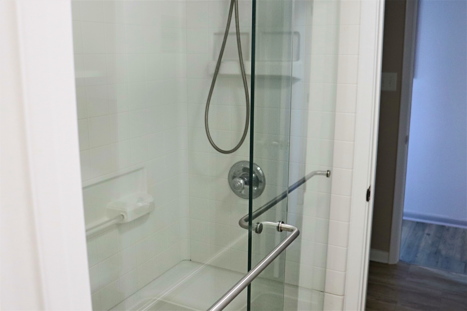 Step into your private glass-enclosed shower with modern fixtures and sleek design for a refreshing start to your day.