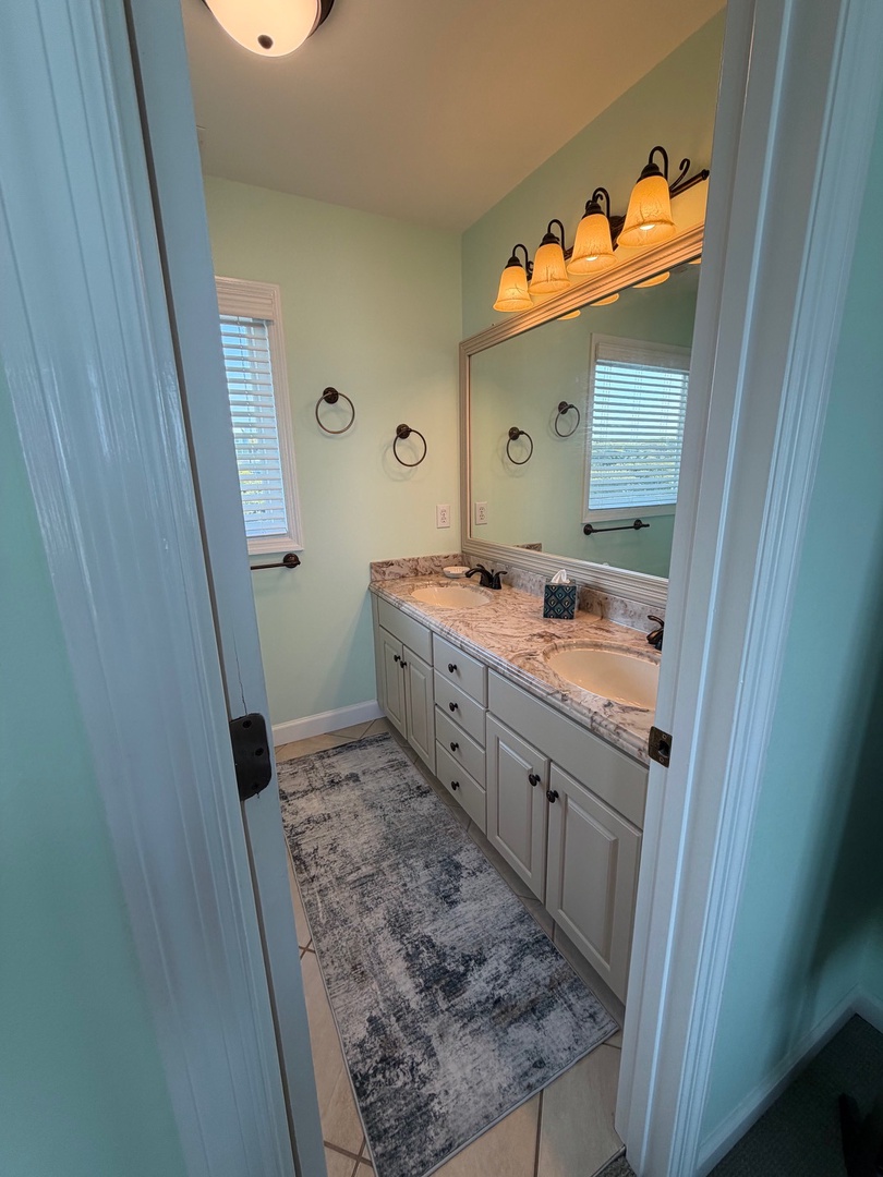 Your spacious bedroom awaits with plush carpeting and warm lighting creating the perfect retreat.