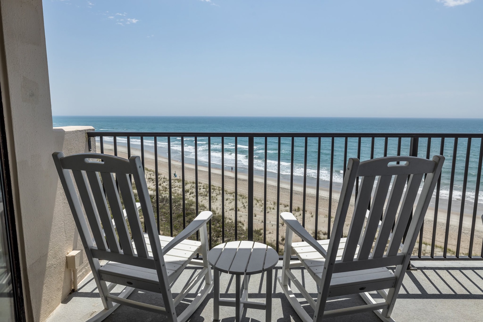 Unwind in your private oceanfront chairs while waves crash below and endless blue horizon stretches before you.