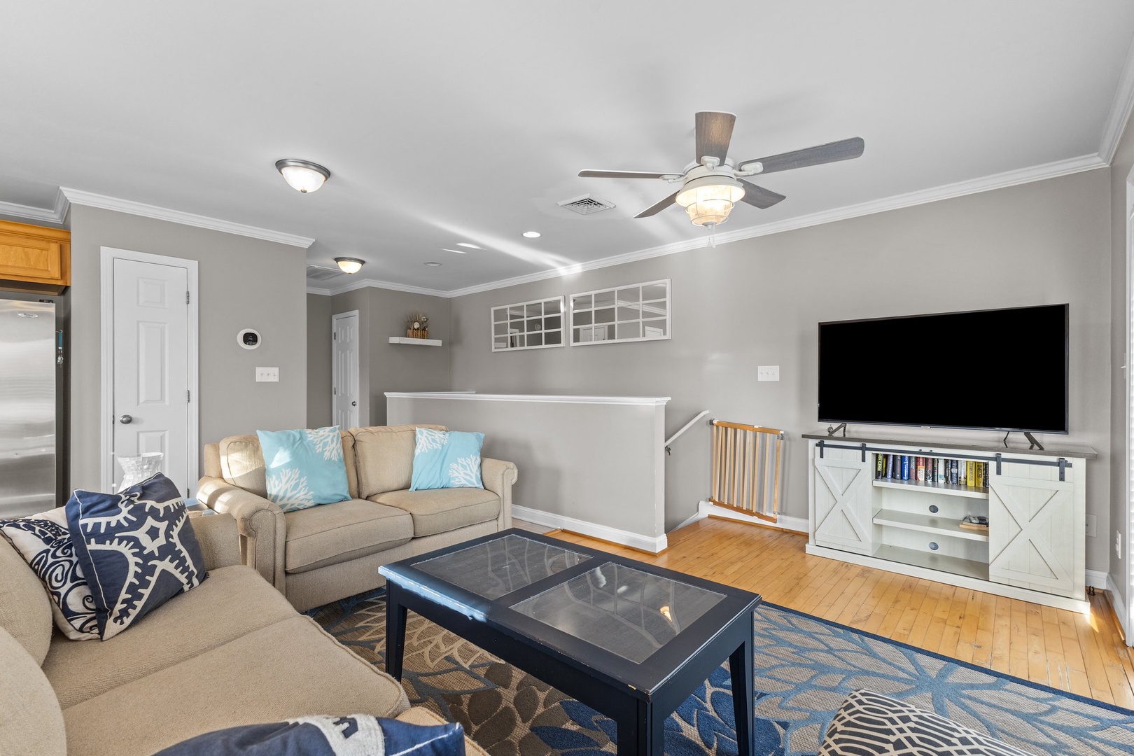 Unwind in this bright living room with comfy seating, large TV for entertainment, and coastal-inspired decor that makes you feel right at home.