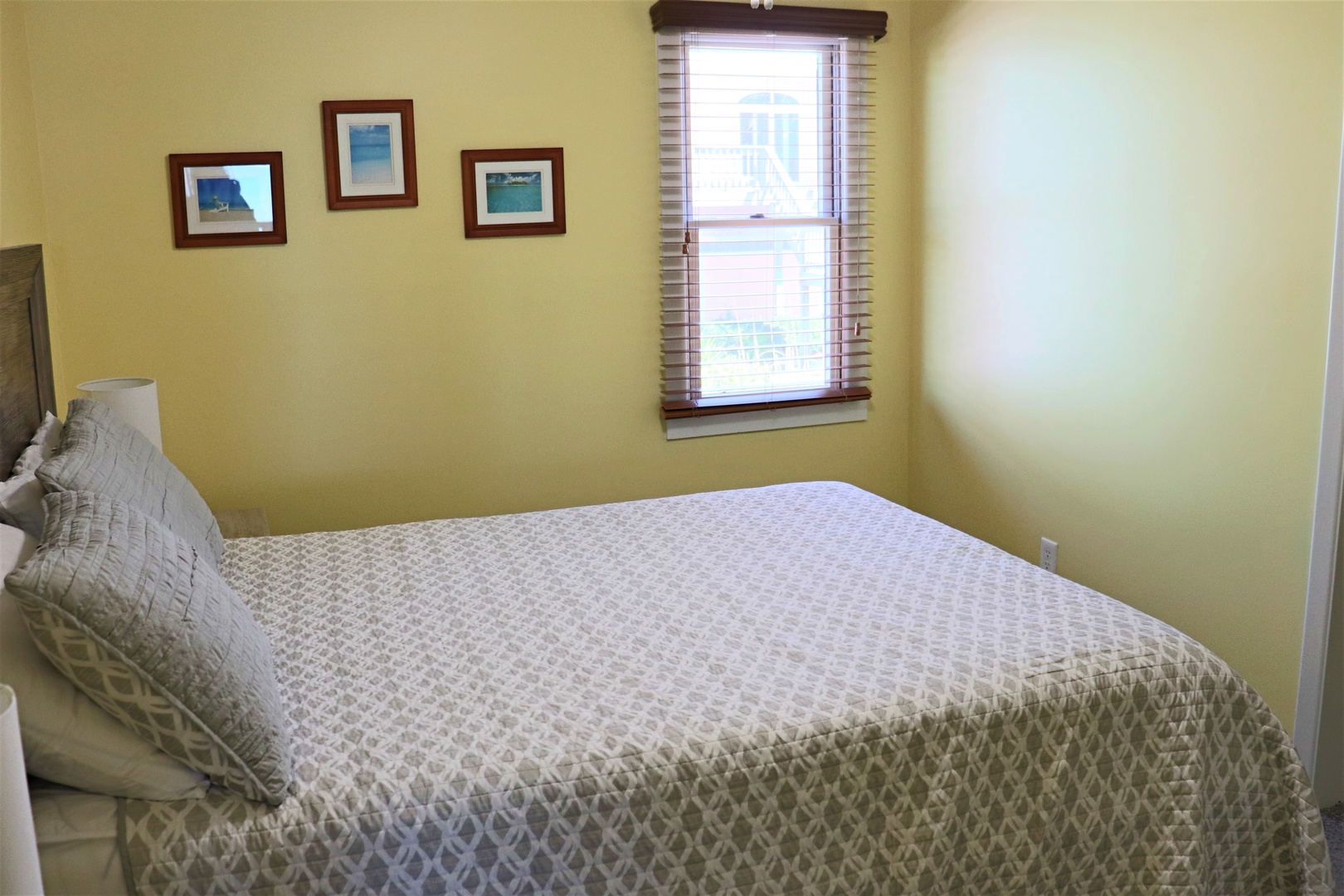 Sink into this cozy bedroom's plush bedding and wake up to gentle natural light streaming through your window.