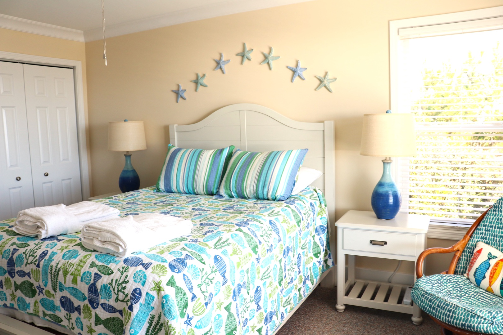 Your coastal retreat awaits with ocean-themed bedding and starfish wall art creating the perfect seaside sanctuary for restful nights.