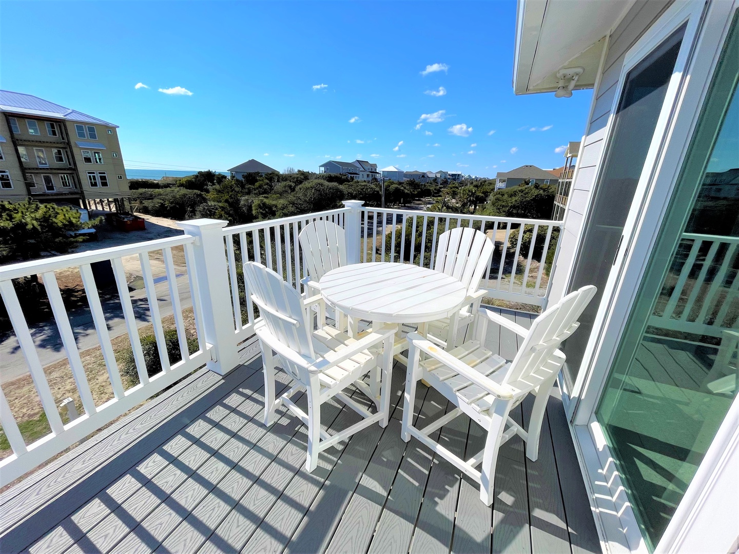 Step onto your private balcony where crisp white furniture awaits your morning coffee while you take in coastal views and ocean breezes.