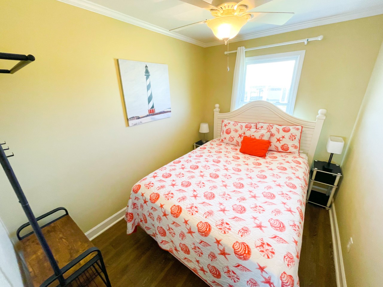 Drift off to sleep in your cozy coastal bedroom with cheerful nautical bedding and charming lighthouse artwork.